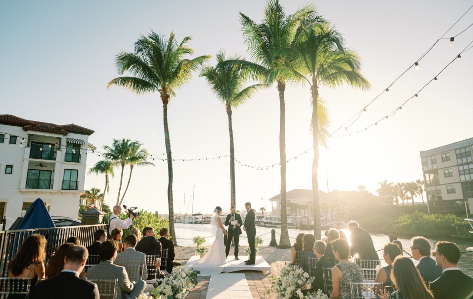 a couple getting married under palm trees