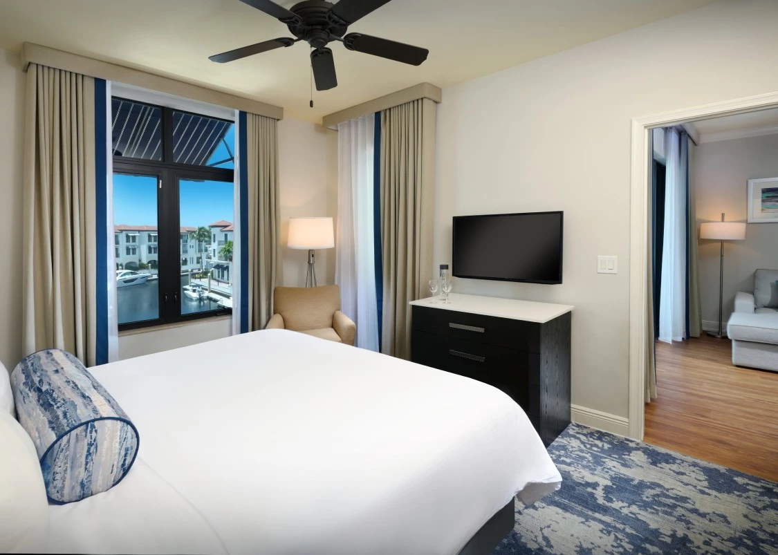a room with a bed and a television