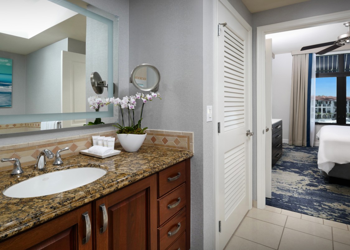 a bathroom with a marble countertop and a mirror