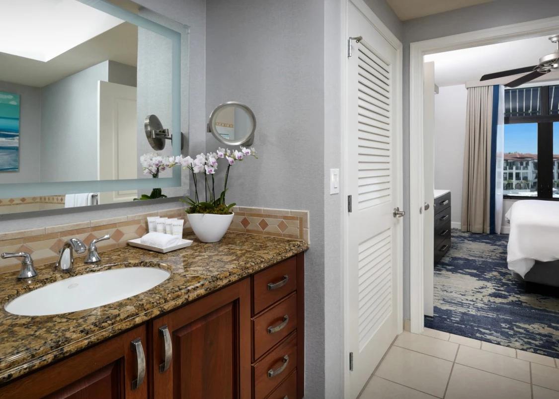 a bathroom with a marble countertop and a mirror