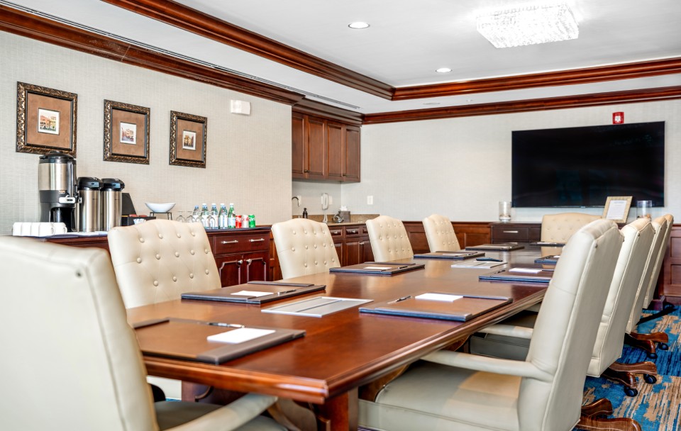a conference room with a table and chairs