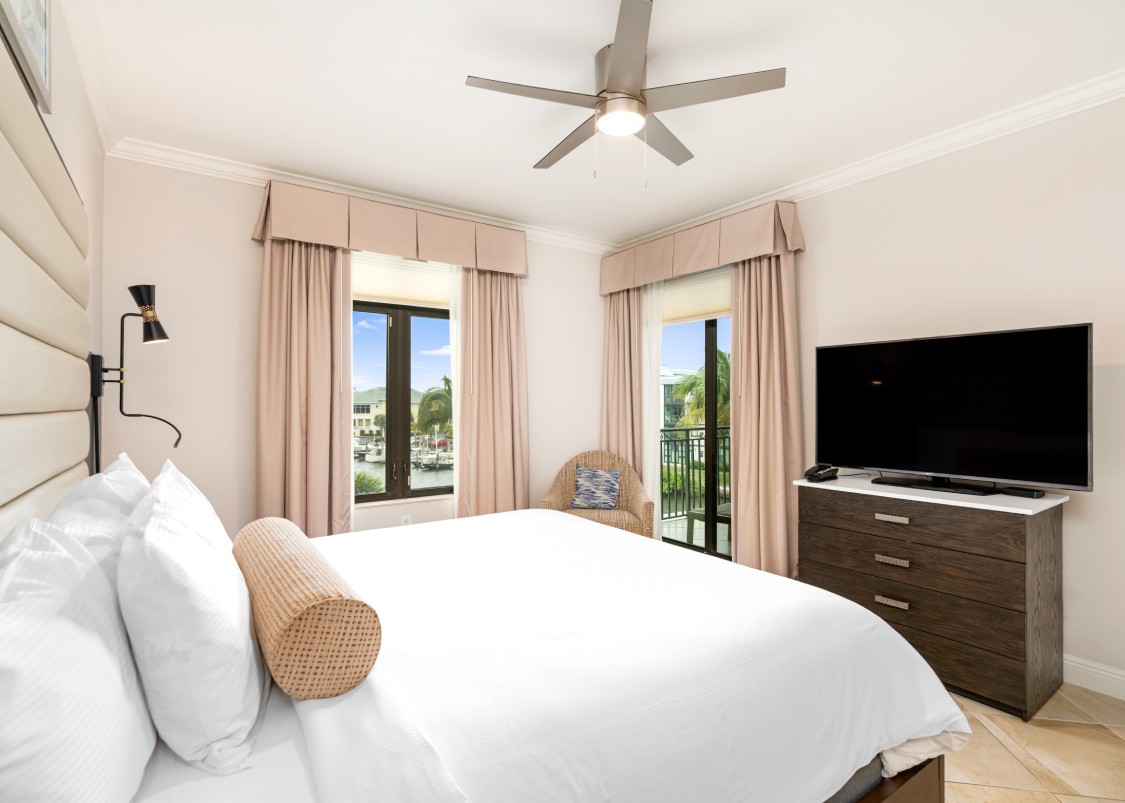 a bedroom with a large bed and a television