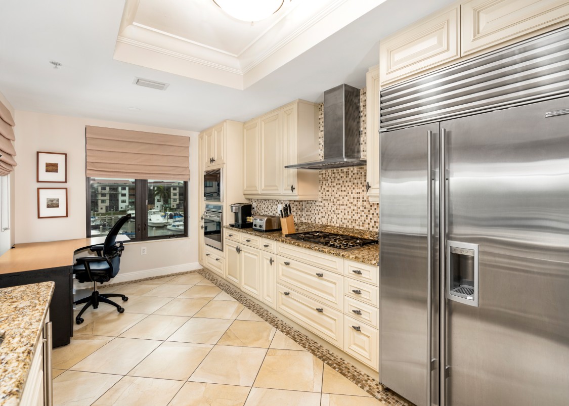 a kitchen with a stainless steel refrigerator