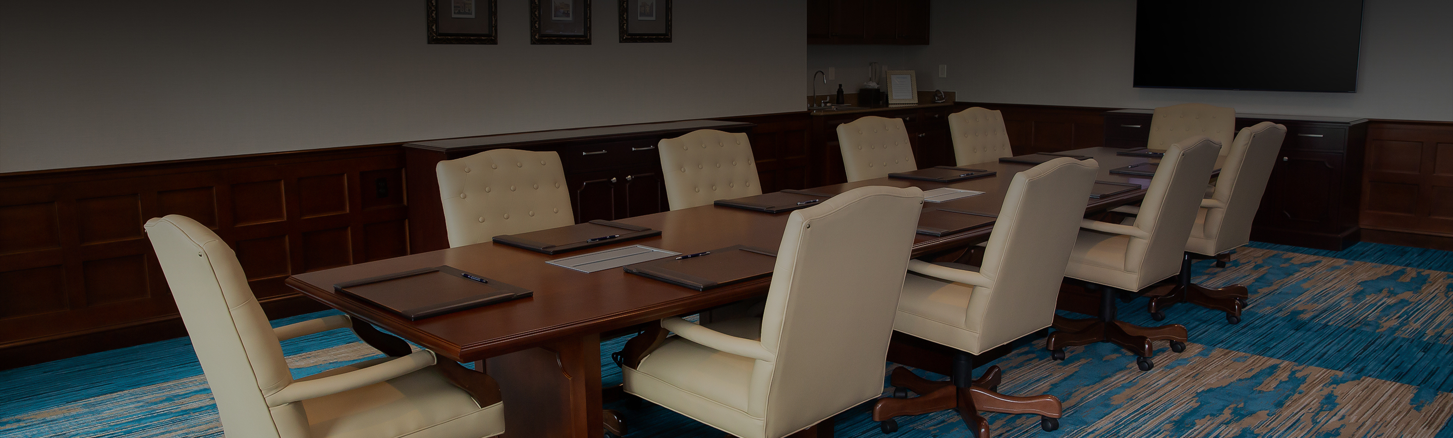 a conference room with a table and chairs