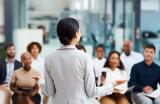 a woman standing in front of a group of people