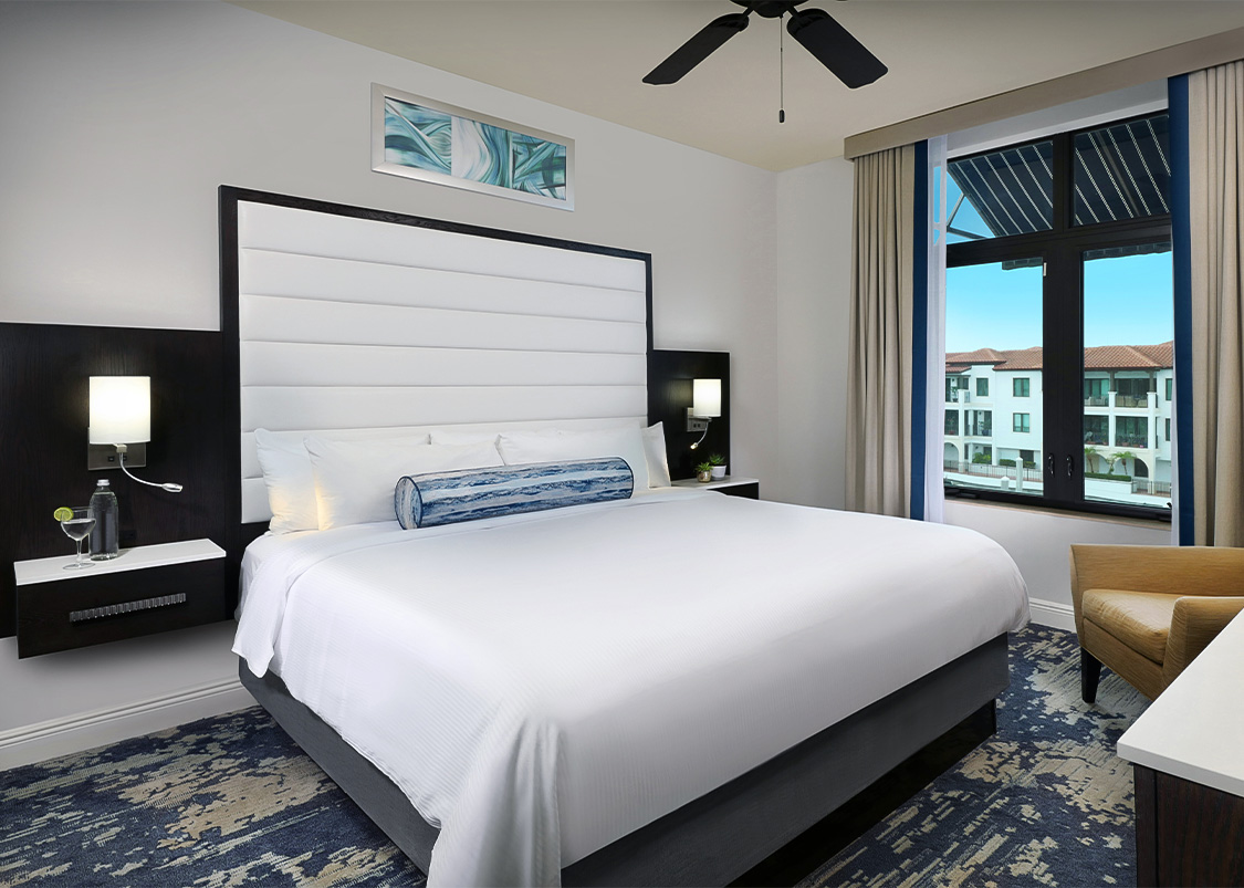 a room with a bed and a ceiling fan