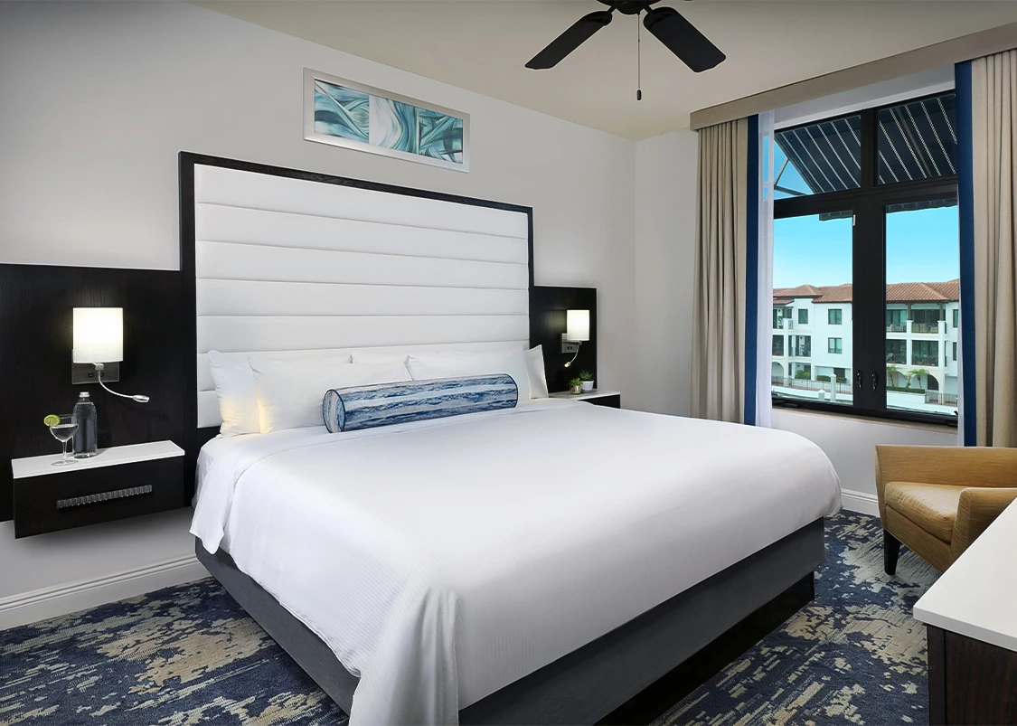 a room with a bed and a ceiling fan
