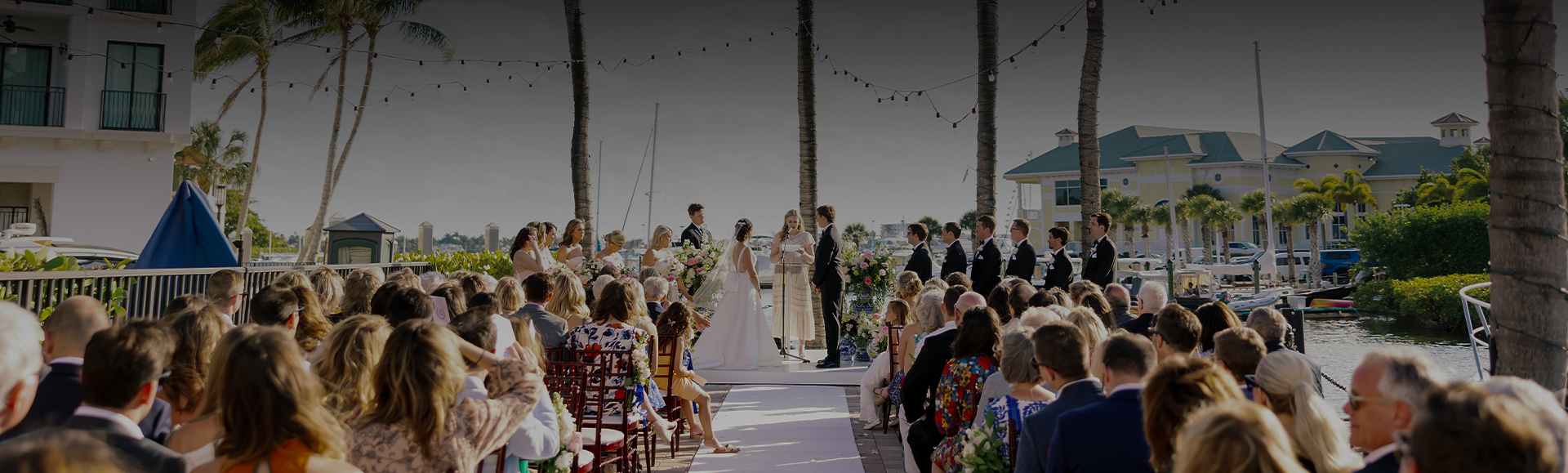 a couple in white dresses on a wedding ceremony