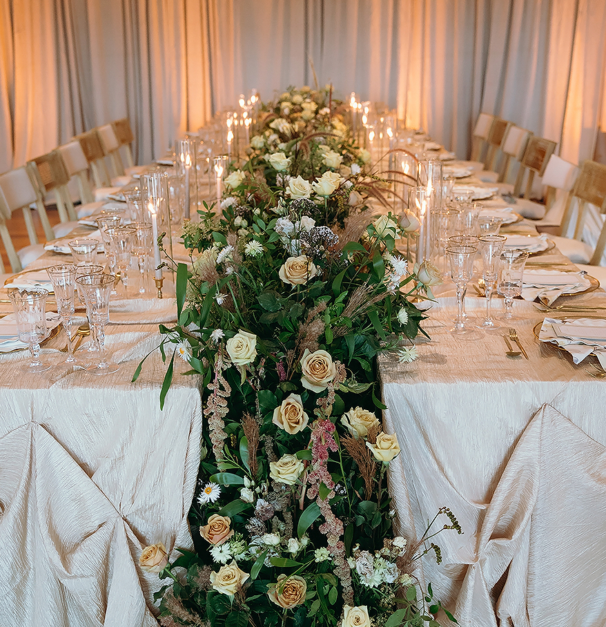 a long table with flowers and candles