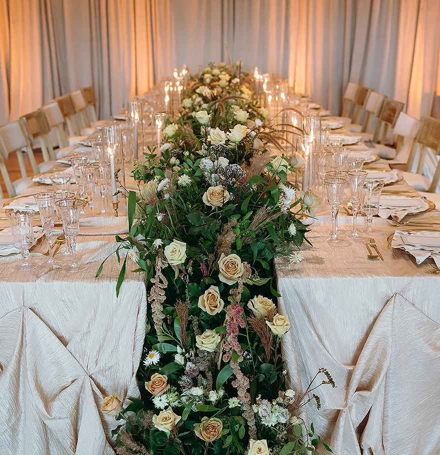 a long table with flowers and candles