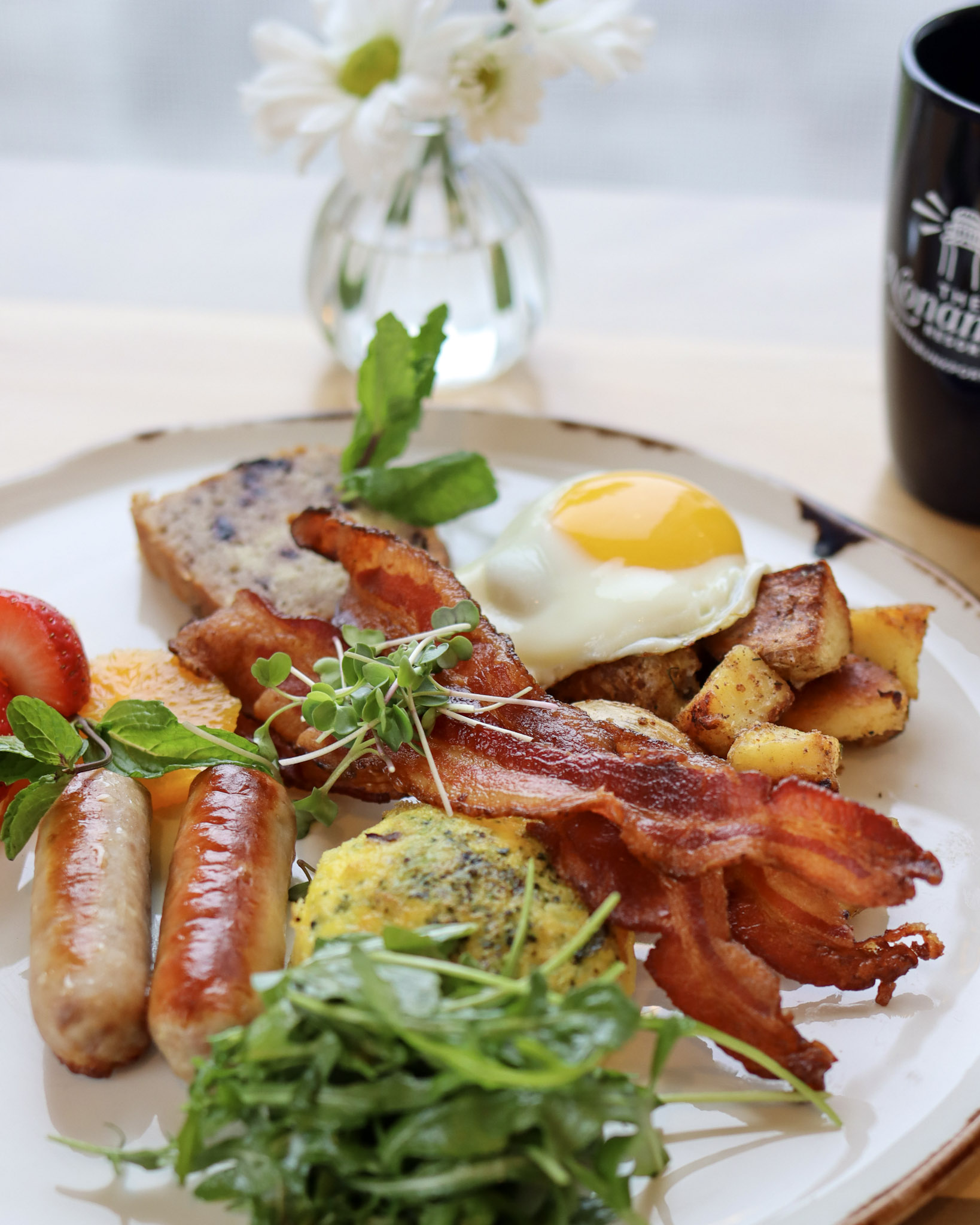 a plate of food with a drink and a bottle of beer