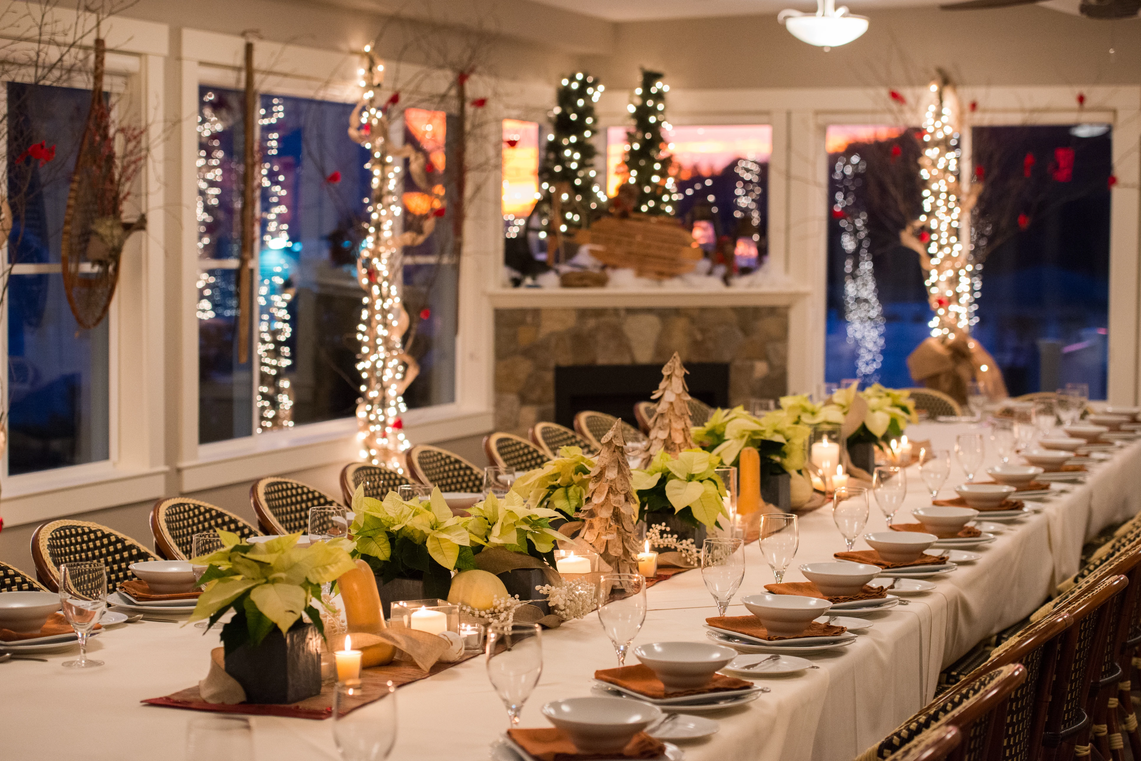 a long table with white tablecloths and candles
