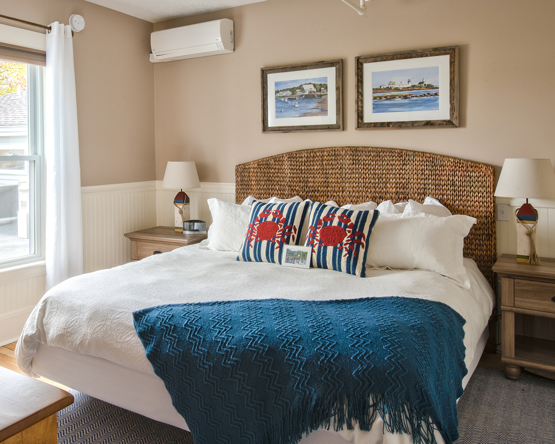 a bed with a blue blanket and pillows