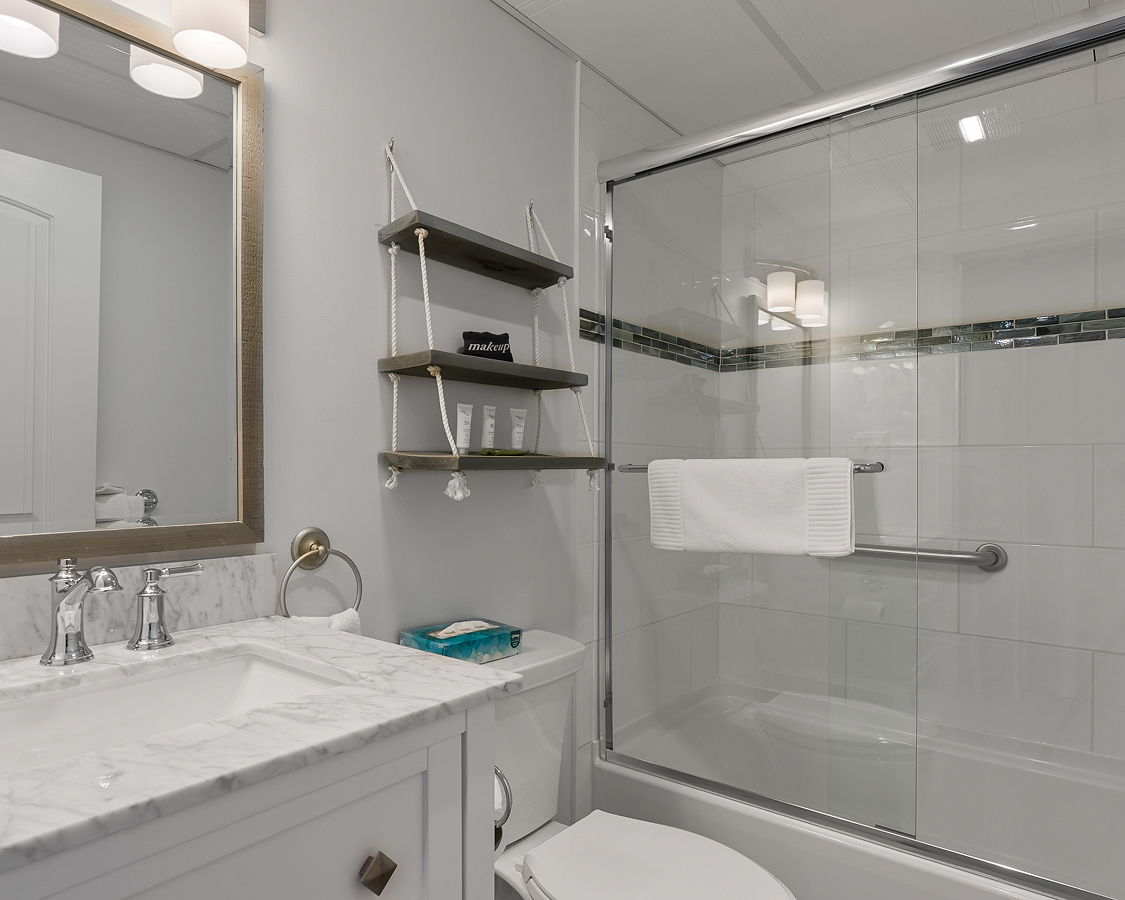 a bathroom with a glass shower and sink