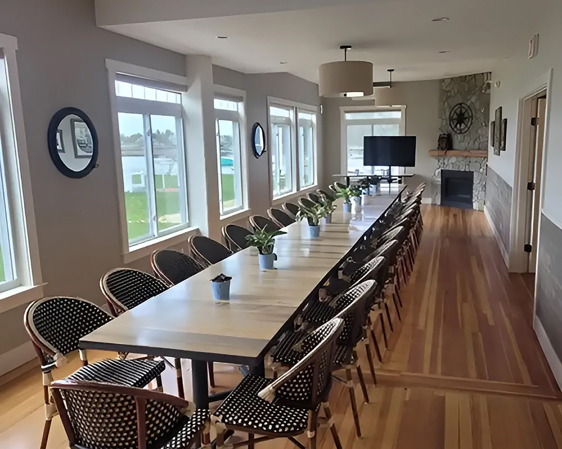a long table with chairs and a television in the middle