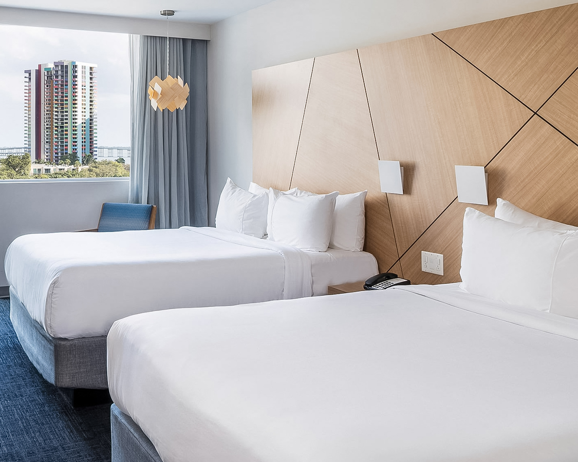 a room with two beds and a window