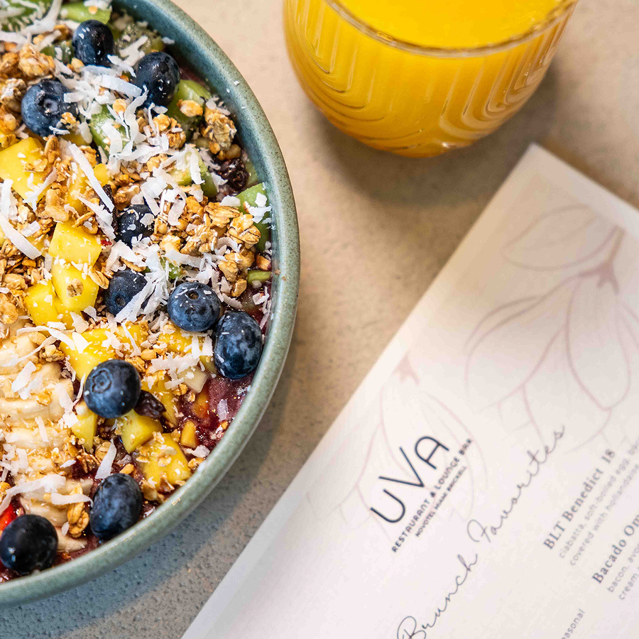 a bowl of fruit and a glass of juice