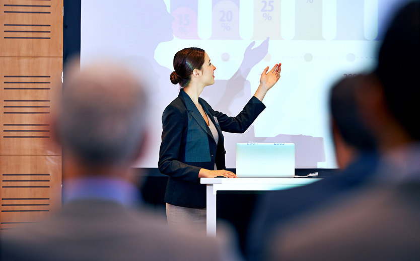 a woman standing in front of a screen