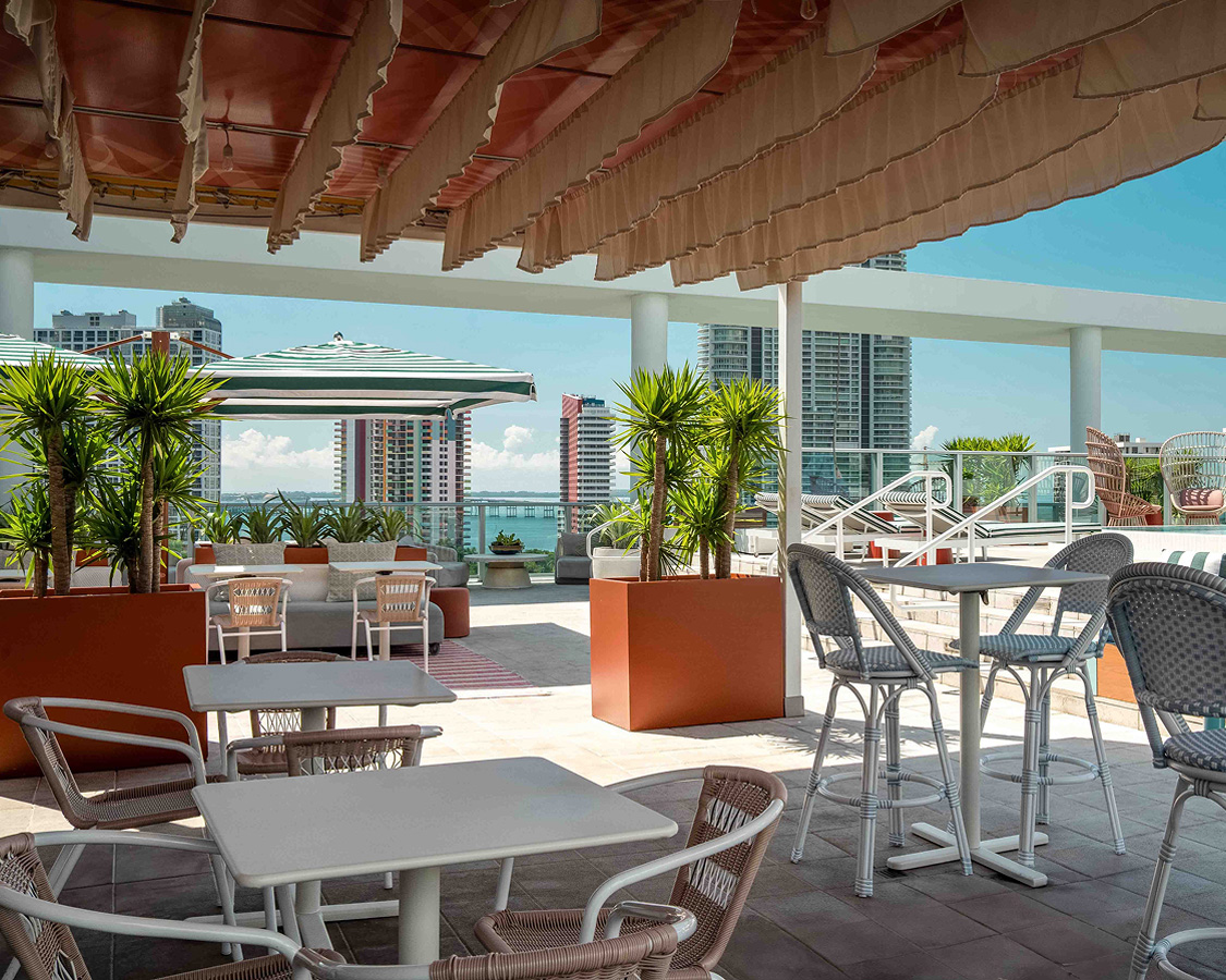 a patio with tables and chairs and umbrellas