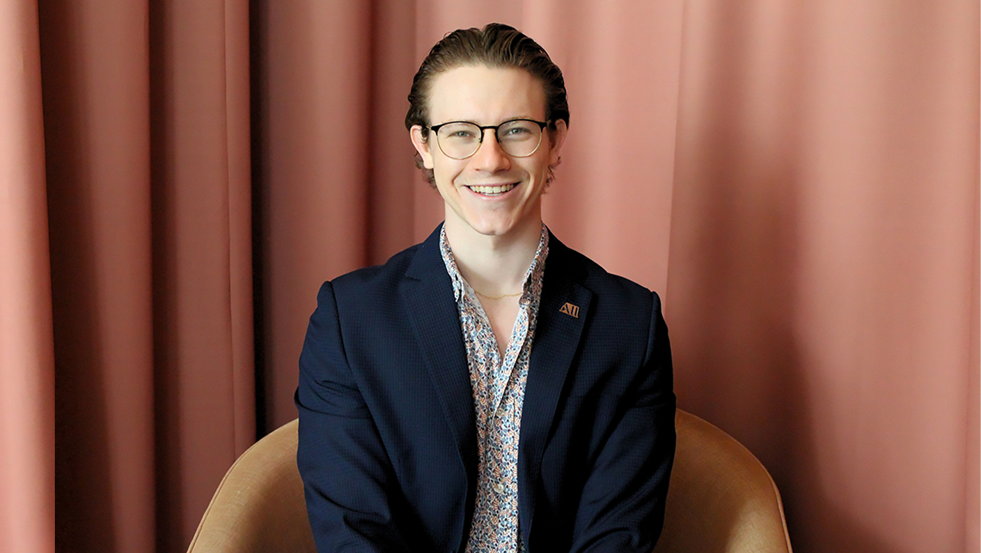 a man wearing glasses and a suit