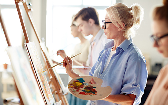 a woman painting on canvas