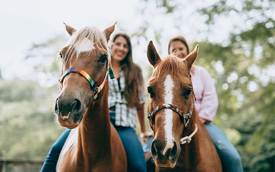 a group of women sitting on horses