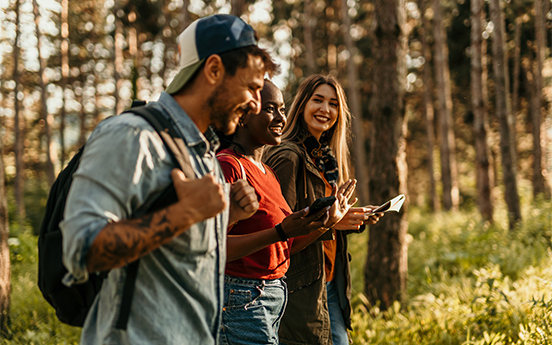 a group of people standing in a forest