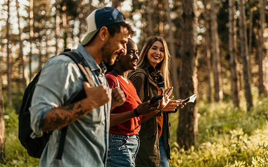 a group of people standing in a forest