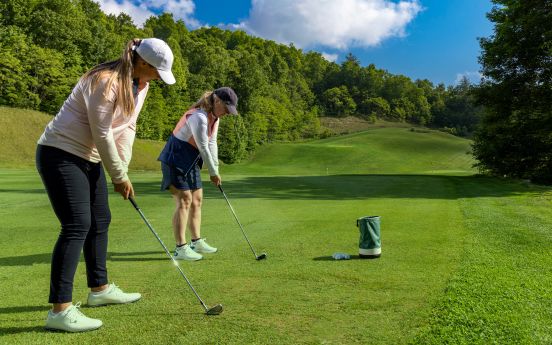 a woman and a woman playing golf