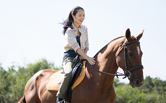 a woman riding a horse