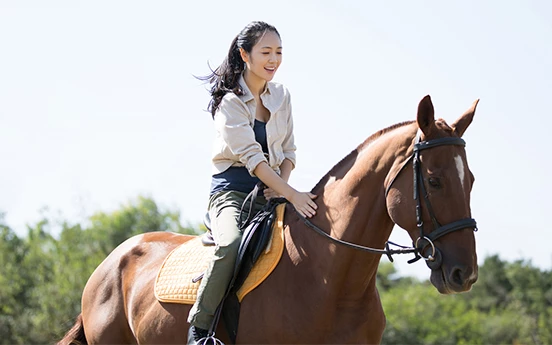 a woman riding a horse