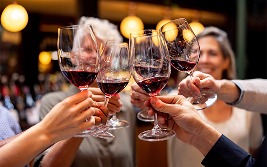 a group of people holding wine glasses