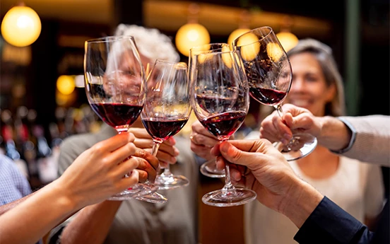 a group of people holding wine glasses