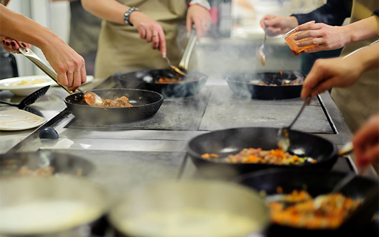 a group of people cooking food
