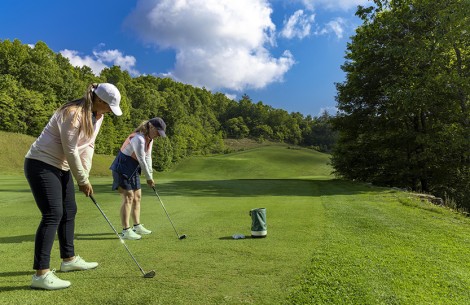 a couple of women playing golf