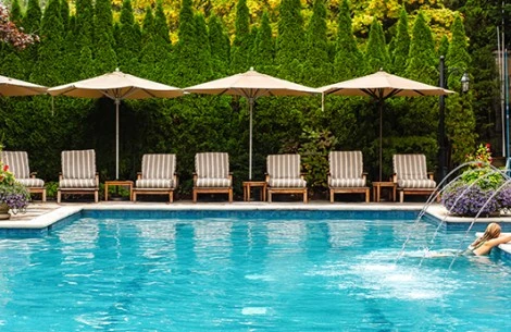 a pool with chairs and umbrellas