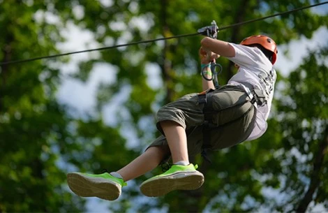a boy in a zip line