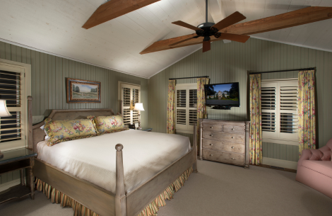 a bedroom with a bed and a television