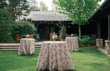 a table covered in cloth with flowers on it