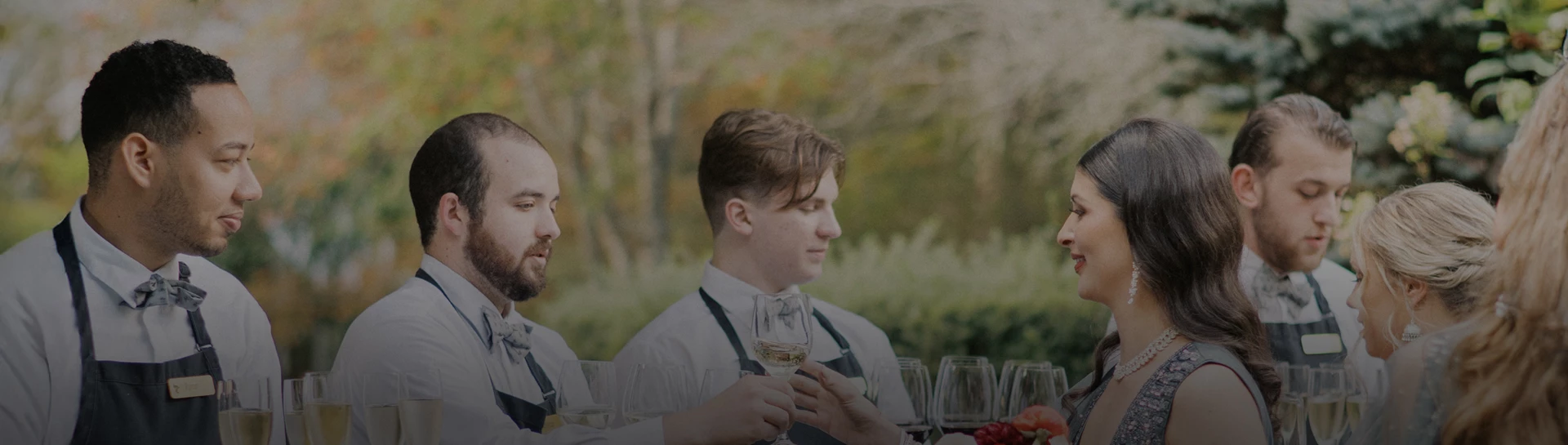 a man holding wine glasses
