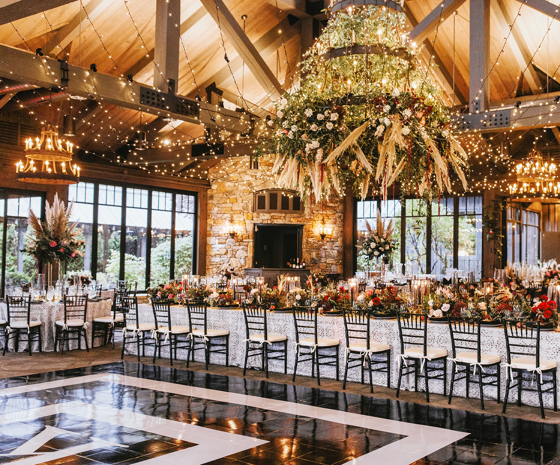 a room with a large chandelier and chairs