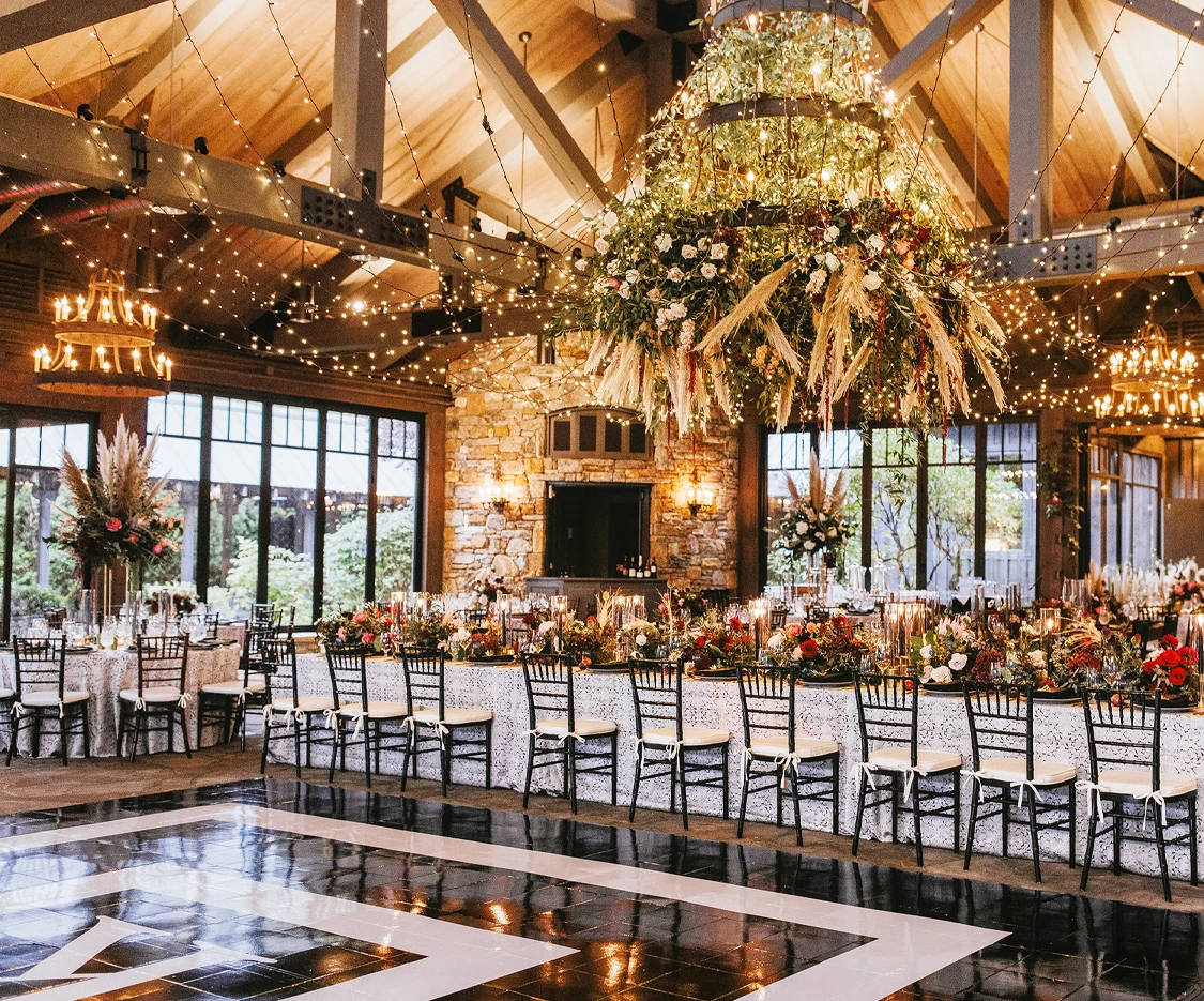 a room with a large chandelier and chairs