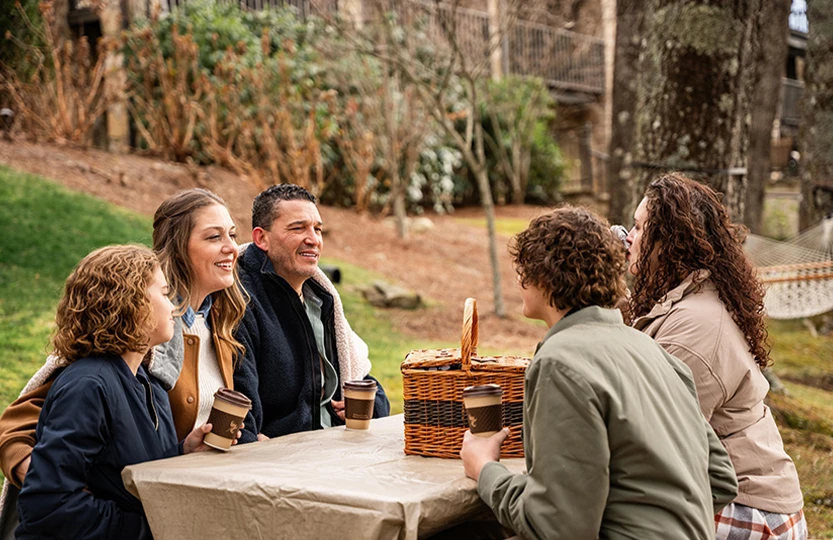 a group of people sitting at a picnic table