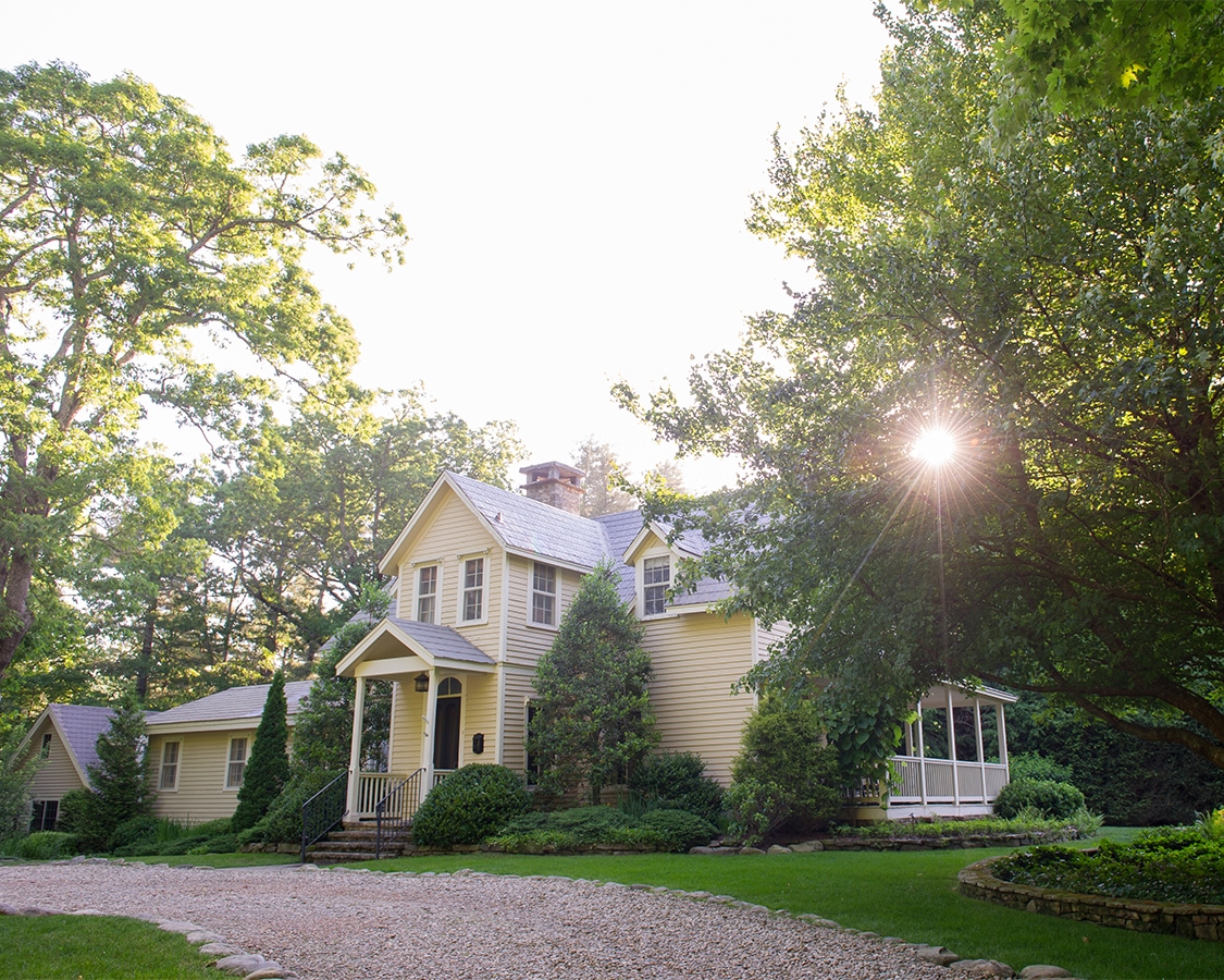 a house with a driveway and trees
