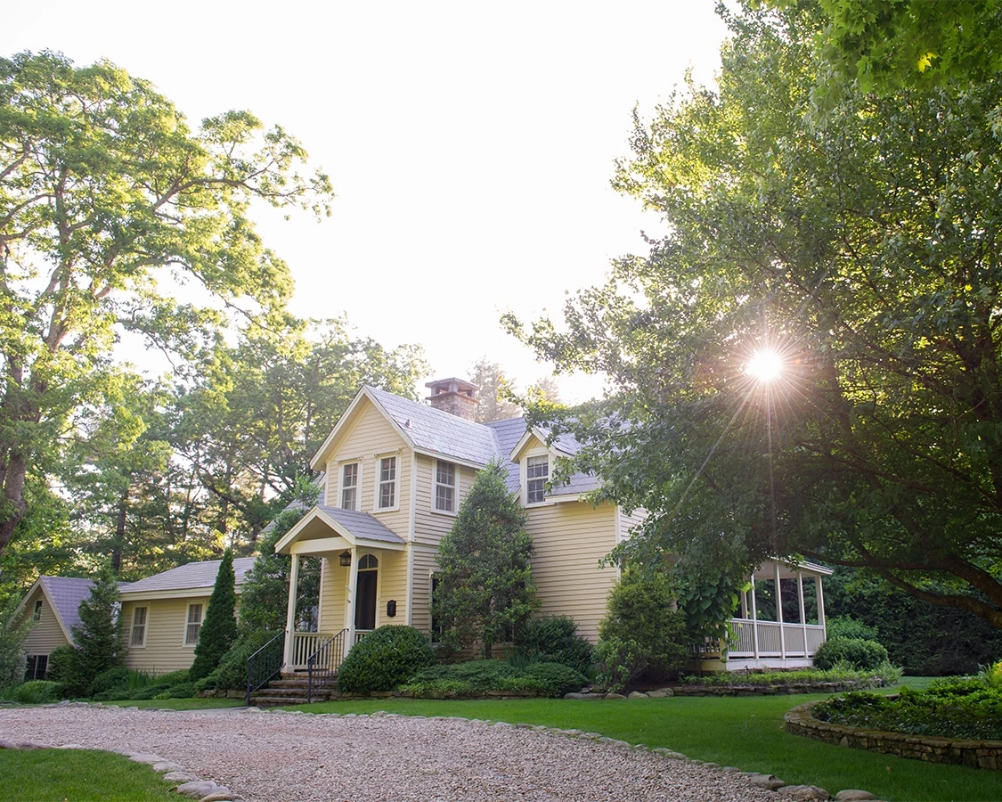 a house with a driveway and trees