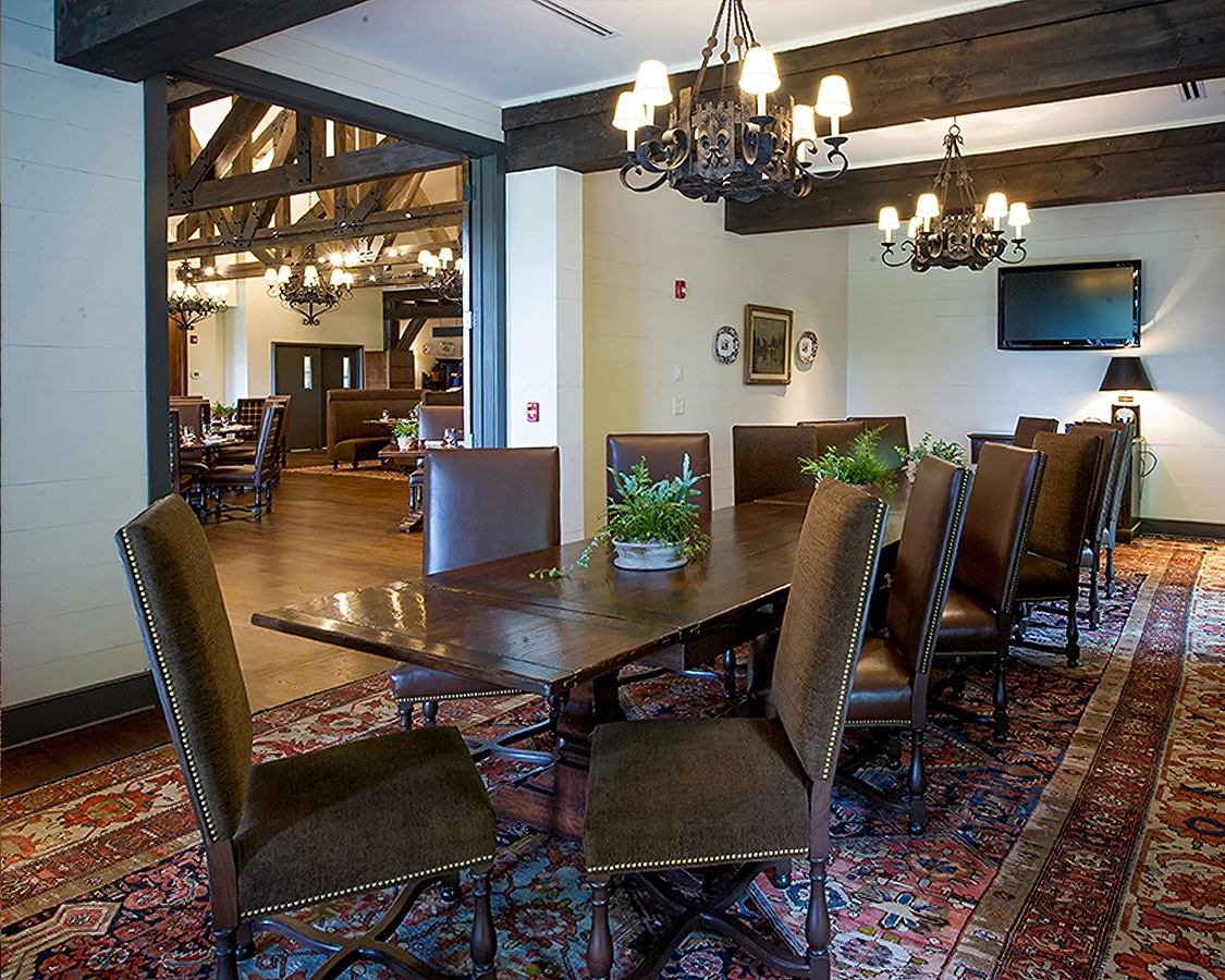 a dining room with a large table and chairs