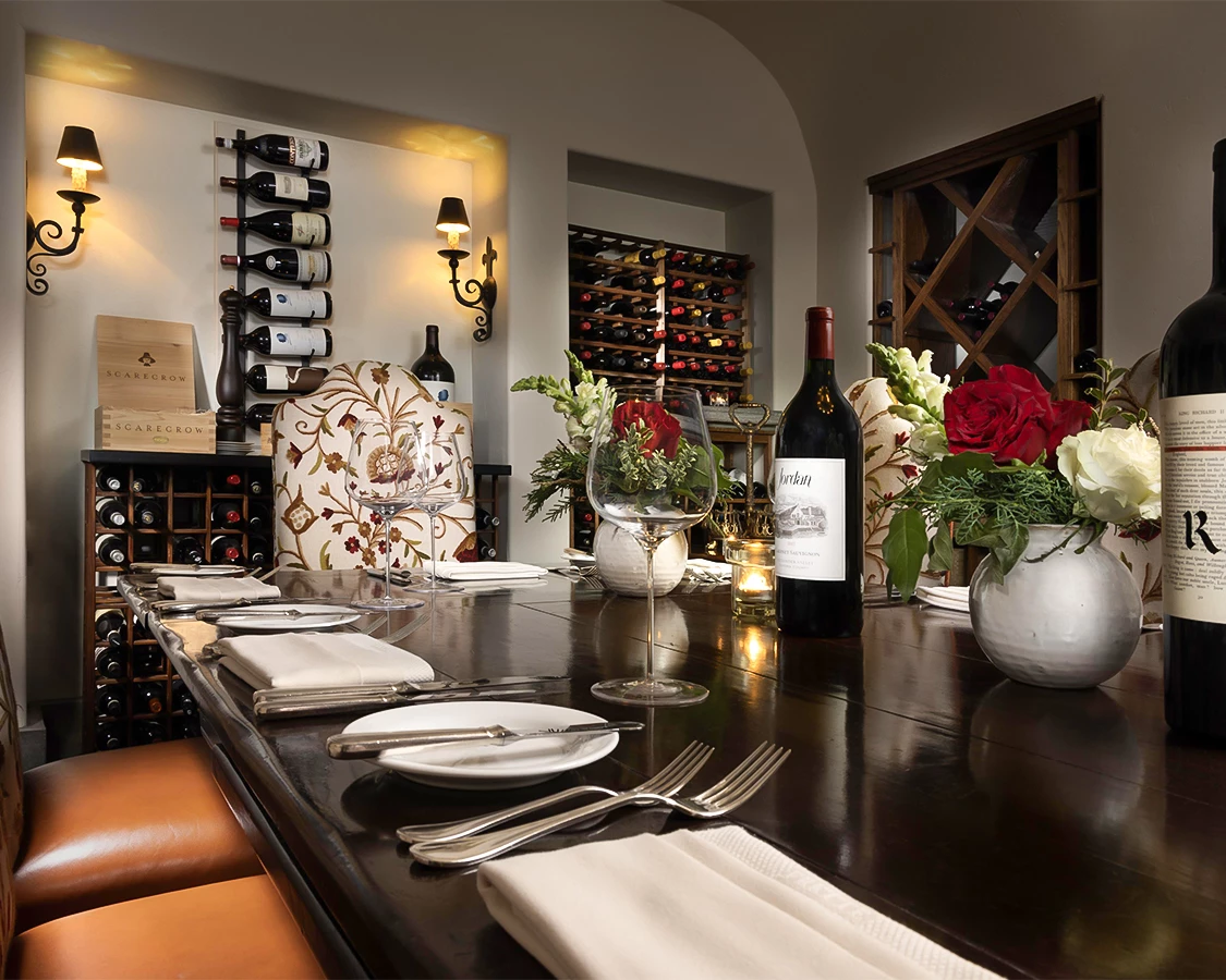 a table with wine glasses and flowers