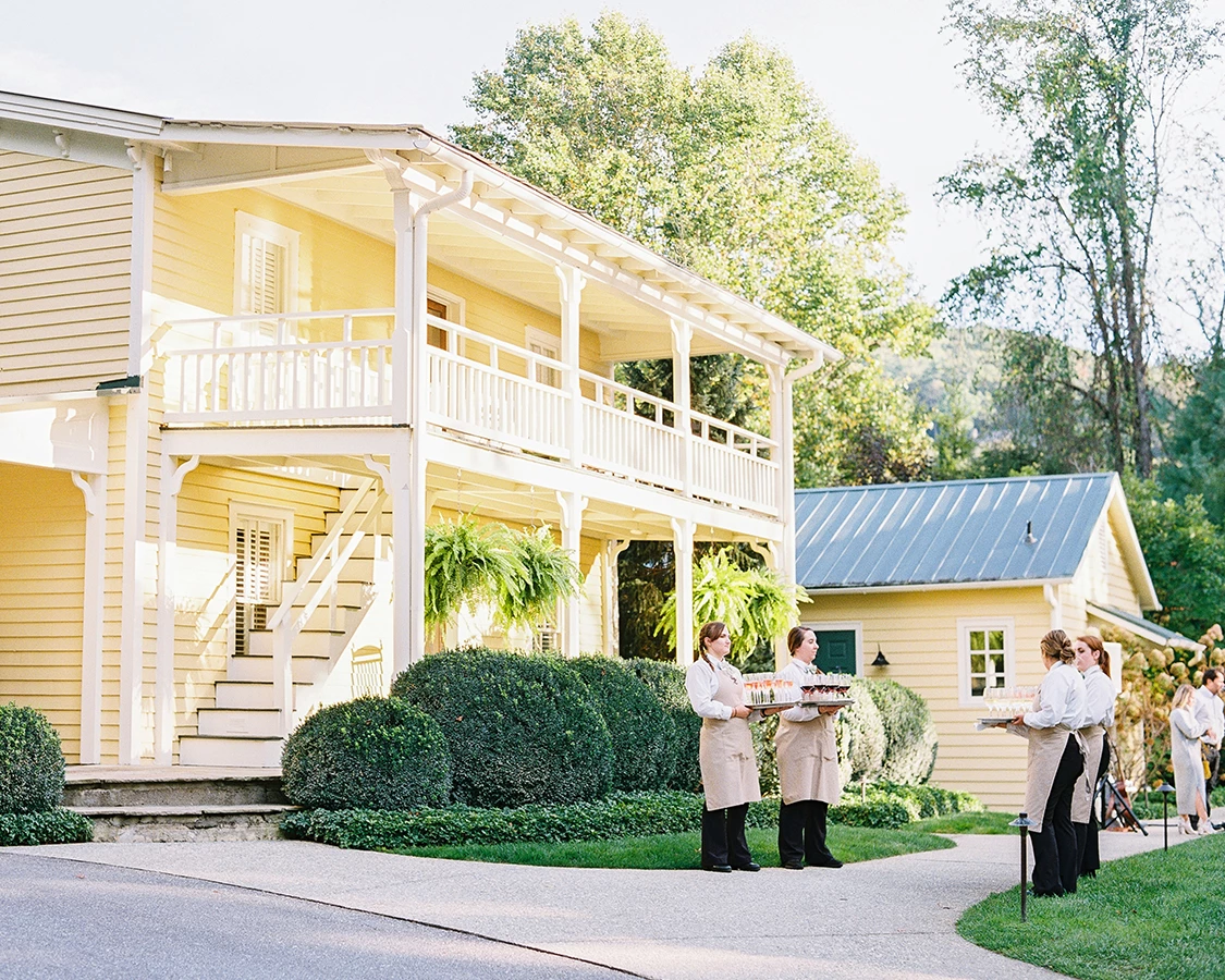 a group of people standing outside a house