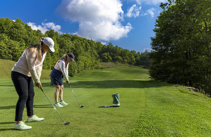 a couple of women playing golf