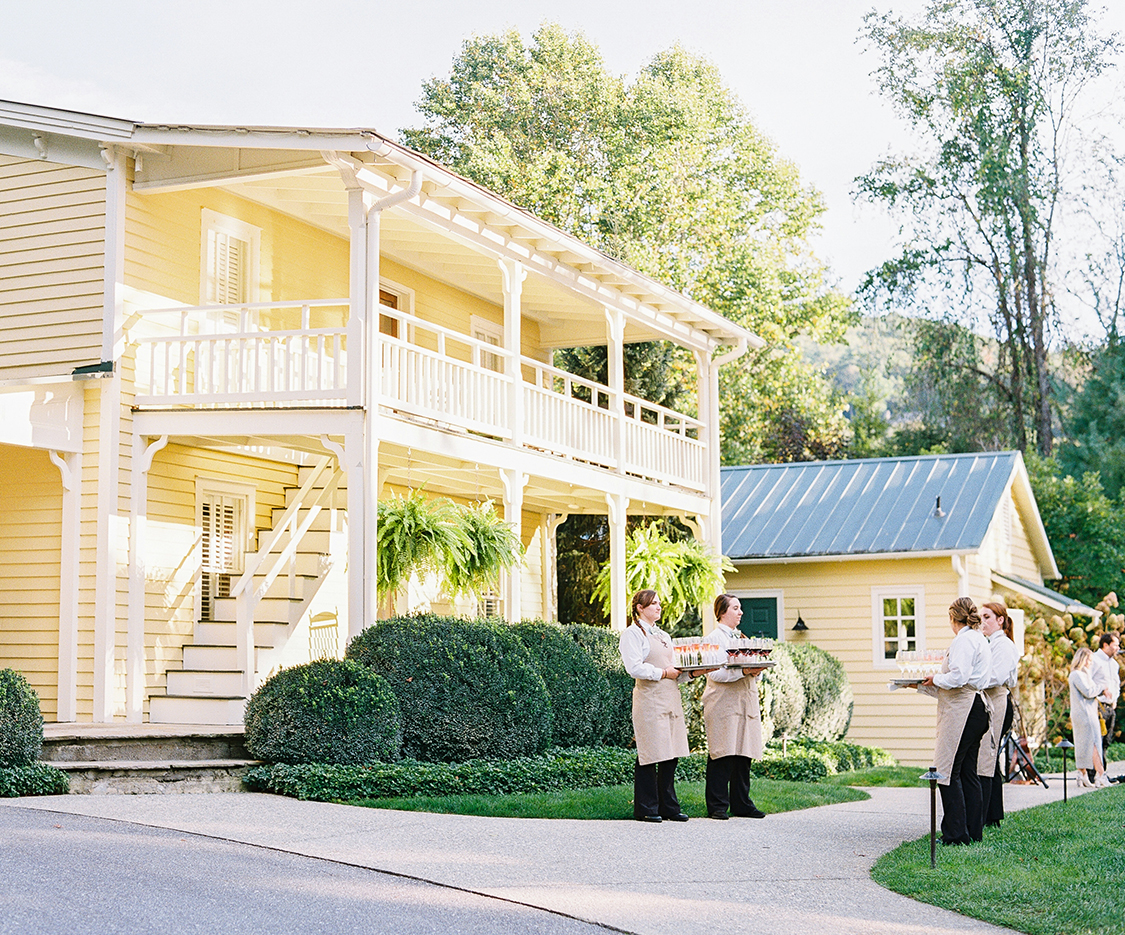 a group of people standing outside a house